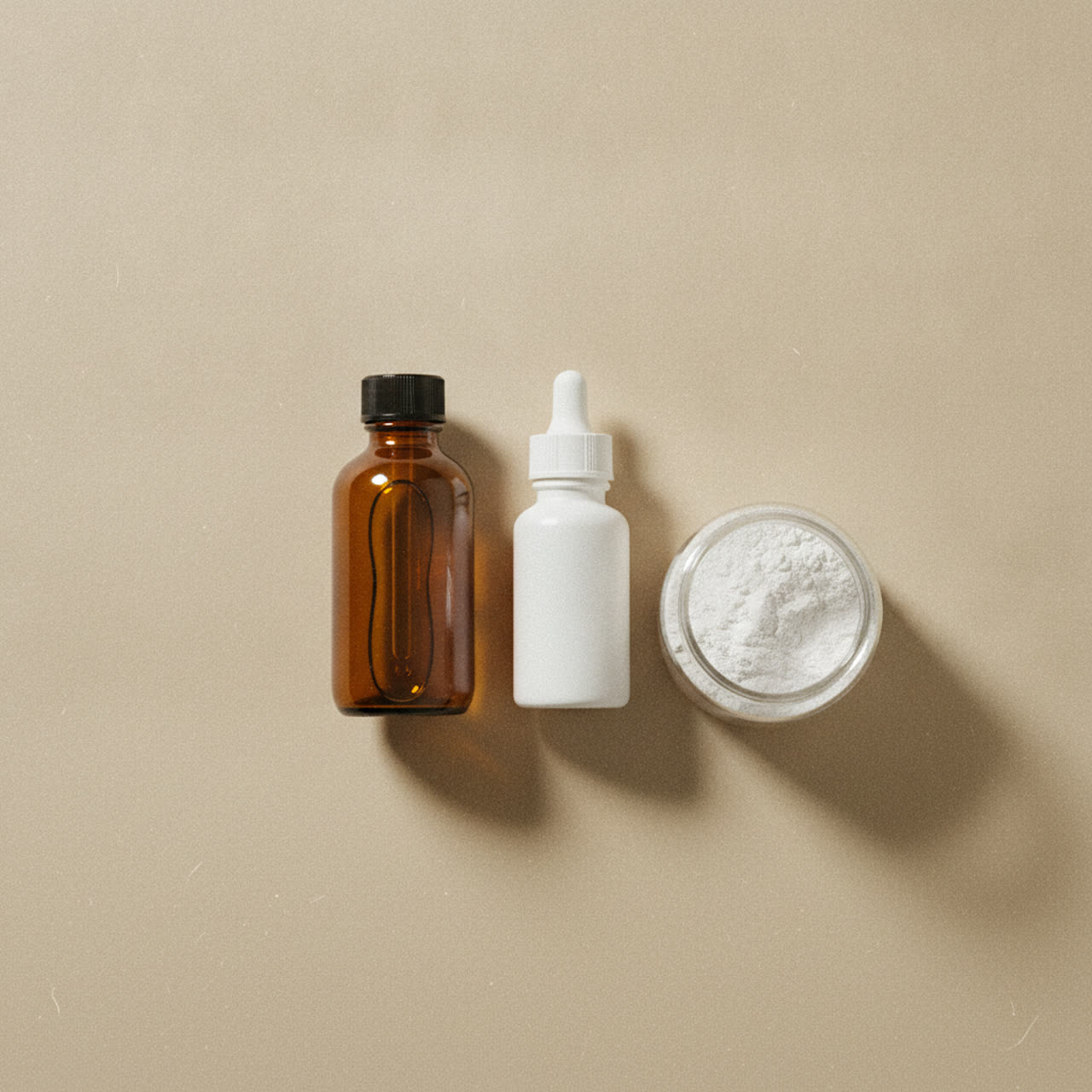 Minimalist flat lay of fish oil, vitamin D and creatine supplement bottles